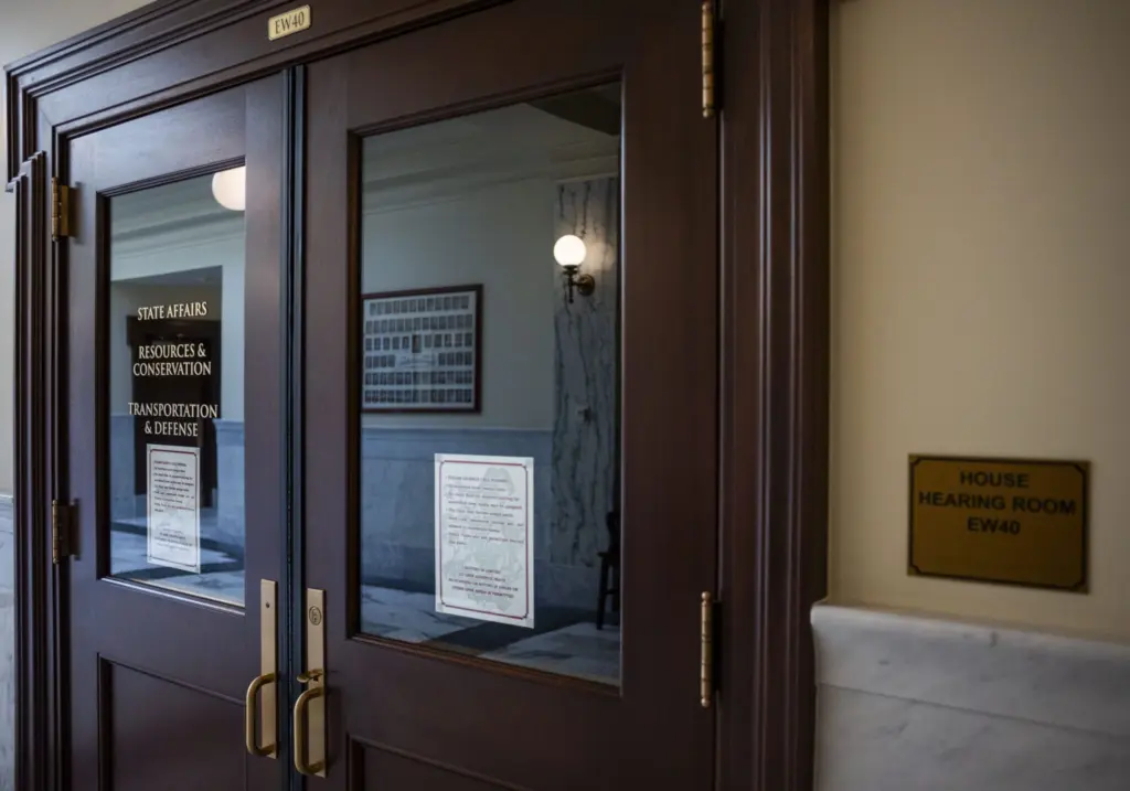 The door to the meeting room for the House’s State Affairs, Resources and Conservation, and Transportation and Defense committees as seen on March 10, 2025, at the Idaho Capitol Building in Boise. (Pat Sutphin for the Idaho Capital Sun)