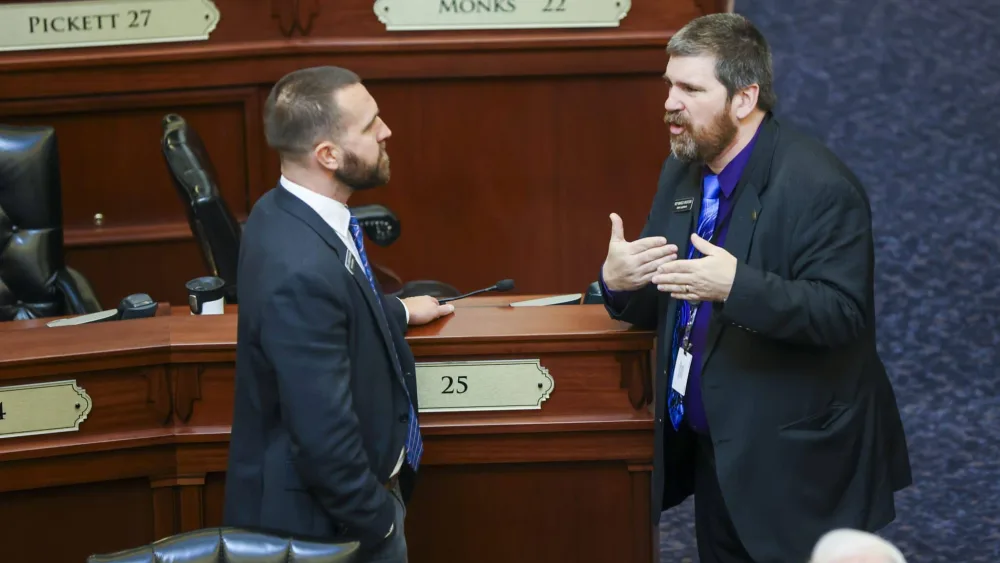 Rep. Jordan Redman, R-Coeur d’Alene, (left) chats with Rep. Marco Erickson, R-Idaho Falls, on Idaho House of Representatives floor before it officially gavels into session on Jan. 14, 2026, at the State Capitol Building in Boise. (Photo by Pat Sutphin for the Idaho Capital Sun)
