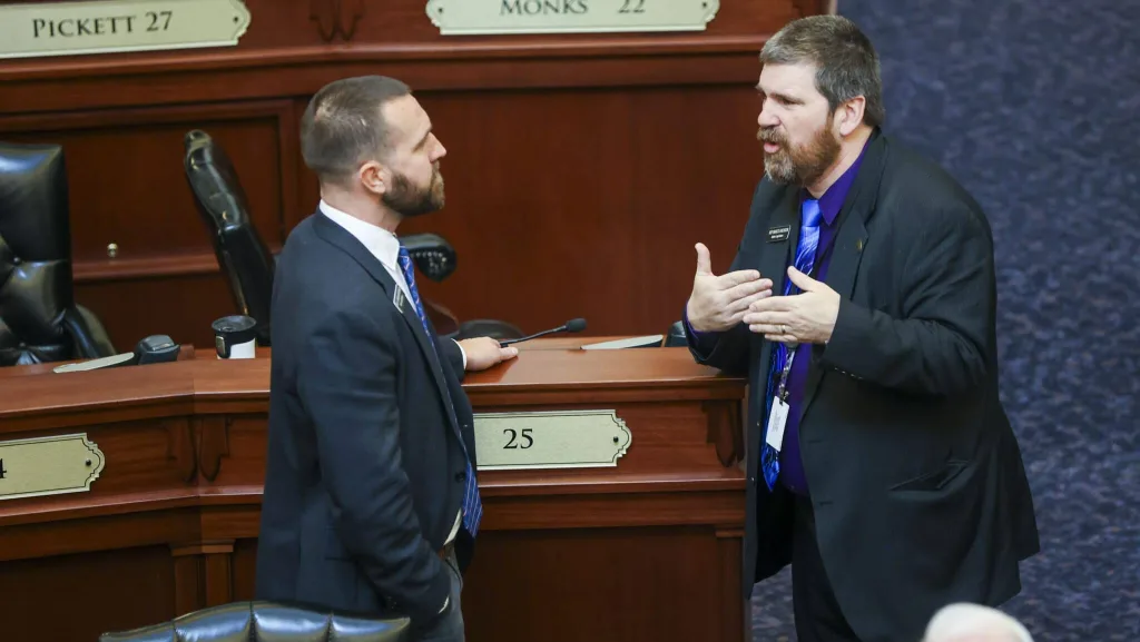 Rep. Jordan Redman, R-Coeur d’Alene, (left) chats with Rep. Marco Erickson, R-Idaho Falls, on Idaho House of Representatives floor before it officially gavels into session on Jan. 14, 2026, at the State Capitol Building in Boise. (Photo by Pat Sutphin for the Idaho Capital Sun)