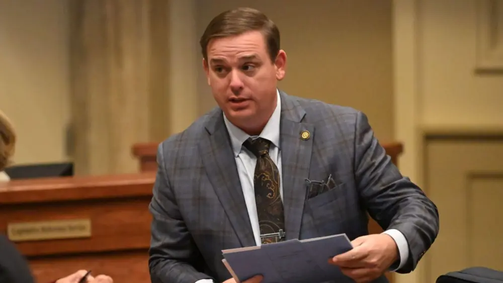 Sen. Matt Woods, R-Jasper, speaks to a colleague on the floor of the Alabama Senate on Jan. 14, 2026 at the Alabama Statehouse in Montgomery, Alabama. The Senate Wednesday passed a bill sponsored by Woods that prohibits civil courts from issuing nondisclosure agreements against survivors of sexual assault. (Brian Lyman/Alabama Reflector)