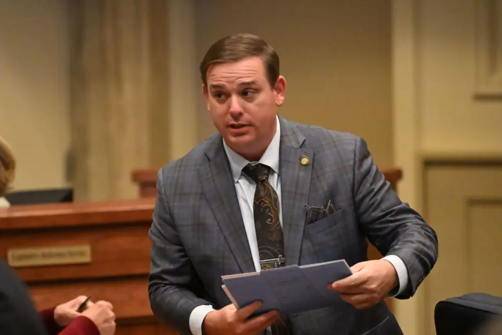 Sen. Matt Woods, R-Jasper, speaks to a colleague on the floor of the Alabama Senate on Jan. 14, 2026 at the Alabama Statehouse in Montgomery, Alabama. The Senate Wednesday passed a bill sponsored by Woods that prohibits civil courts from issuing nondisclosure agreements against survivors of sexual assault. (Brian Lyman/Alabama Reflector)