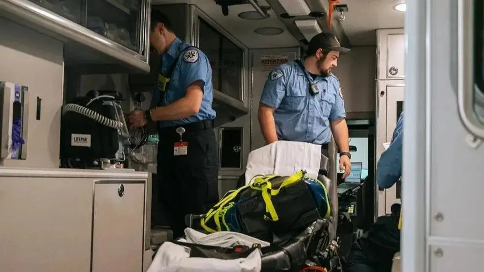Paramedics work inside an ambulance, preparing medical equipment and supplies. Photo: Grace David / The Center Square
