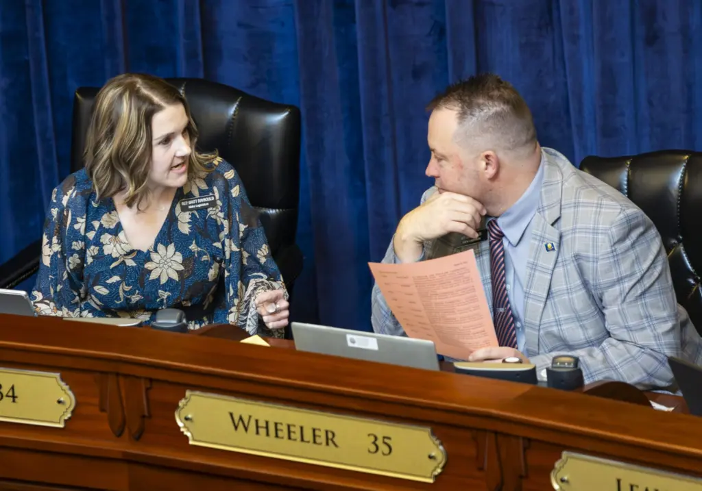 Reps. Britt Raybould, R-Rexburg, (left) and Josh Wheeler, R-Ammon, chat before a floor session in the House on March 10, 2025, at the Idaho Capitol Building in Boise. (Pat Sutphin for the Idaho Capital Sun)