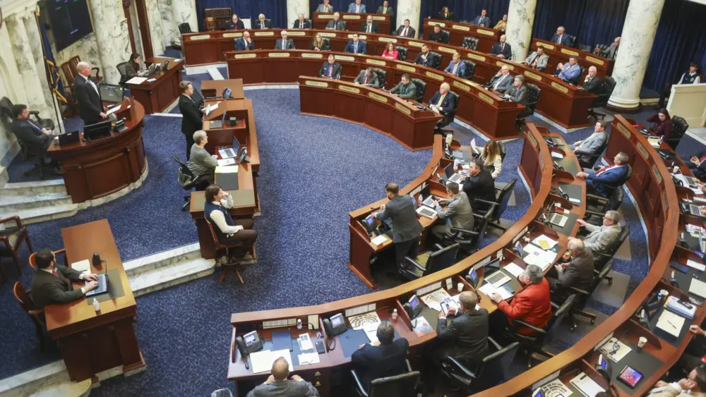 State lawmakers conduct legislative business from the Idaho House of Representatives floor on Jan. 14, 2026, at the State Capitol Building in Boise. (Photo by Pat Sutphin for the Idaho Capital Sun)