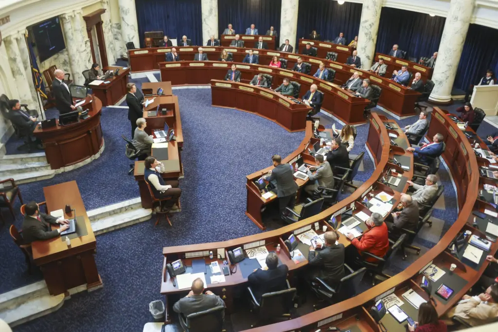 State lawmakers conduct legislative business from the Idaho House of Representatives floor on Jan. 14, 2026, at the State Capitol Building in Boise. (Photo by Pat Sutphin for the Idaho Capital Sun)