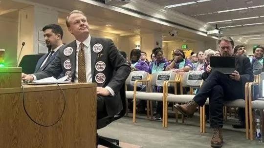 Anti-tax activist Tim Eyman testifies against the income tax bill. Seated behind him in the front row of chairs is Let's Go Washington founder Brian Heywood. Photo by Carleen Johnson