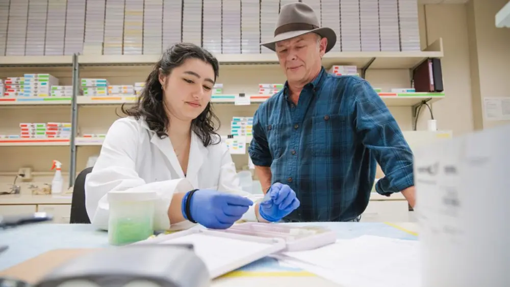 Sarah De Santos, an undergraduate research assistant, and Professor Michael Skinner work together in the laboratory (photo courtesy of WSU).