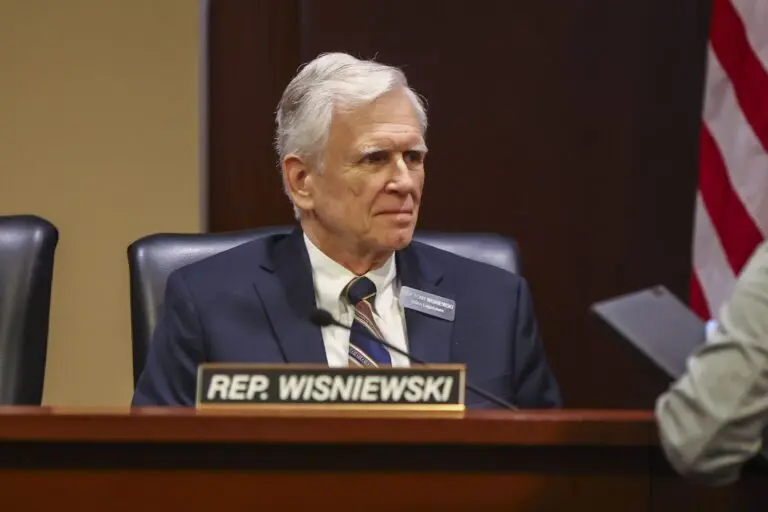 Rep. Tony Wisniewski, R-Post Falls, chats with a colleague before the House Education Committee meeting on Jan. 14, 2026, at the State Capitol Building in Boise. (Photo by Pat Sutphin for the Idaho Capital Sun)
