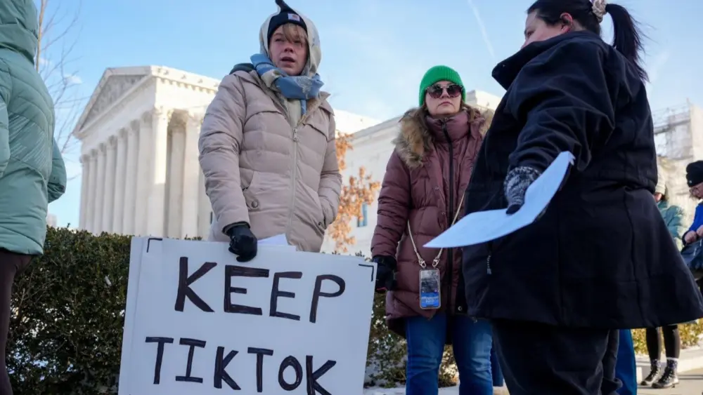 Sarah Baus of Charleston, S.C., holds a sign that reads “Keep TikTok” as she and other content creators Sallye Miley of Jackson, Mississippi, and Callie Goodwin of Columbia, S.C., stand outside the U.S. Supreme Court Building on Jan. 10, 2025, as the court hears oral arguments on whether to overturn or delay a law that could lead to a ban of TikTok in the U.S. (Photo by Andrew Harnik/Getty Images)