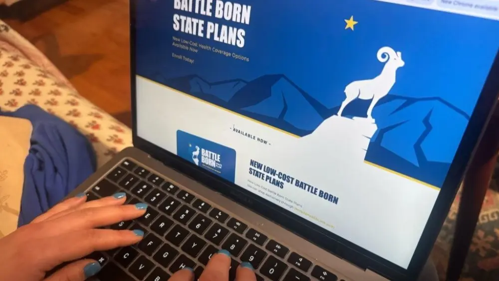 A woman looks at health insurance options on Nevada’s health exchange. This year Nevada became the third state to add a public option plan to its marketplace. (Photo by Shalina Chatlani/ Stateline)