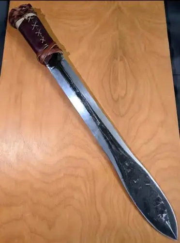 The completed sword features a decorative leather-wrapped handle with detailed twine work, enhancing both its visual appeal and historical accuracy while remaining fully functional (photo by Shelly Hanks, WSU Photo Services).