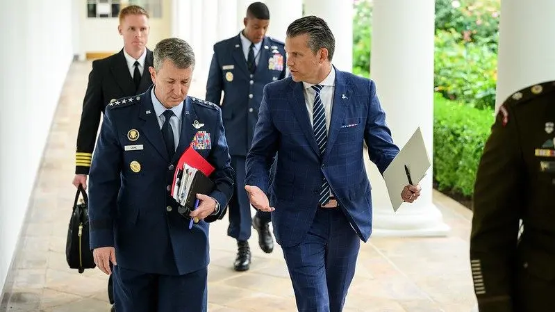 Defense Secretary Pete Hegseth and Joint Chiefs Chairman Gen. Dan Caine walk along the West Colonnade of the White House, Aug. 18, 2025. Photo: Molly Riley / Official White House Photo via Flickr / United States Government Work