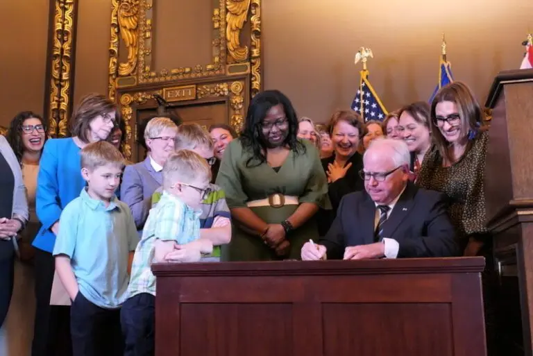 Gov. Tim Walz signs paid family and medical leave into law on May 25, 2023. New research shows millions of Americans are now covered under state-mandated paid leave programs that provide time off for illness or to care for others. (Photo by Max Nesterak/Minnesota Reformer)