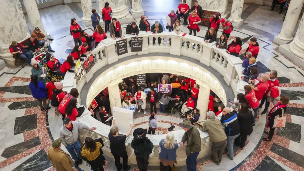 Protesters gather on multiple levels of the rotunda of the Idaho Capitol on Jan. 12, 2026, to rally against budget cuts to the state’s Medicaid program and health services. (Photo by Pat Sutphin for the Idaho Capital Sun)