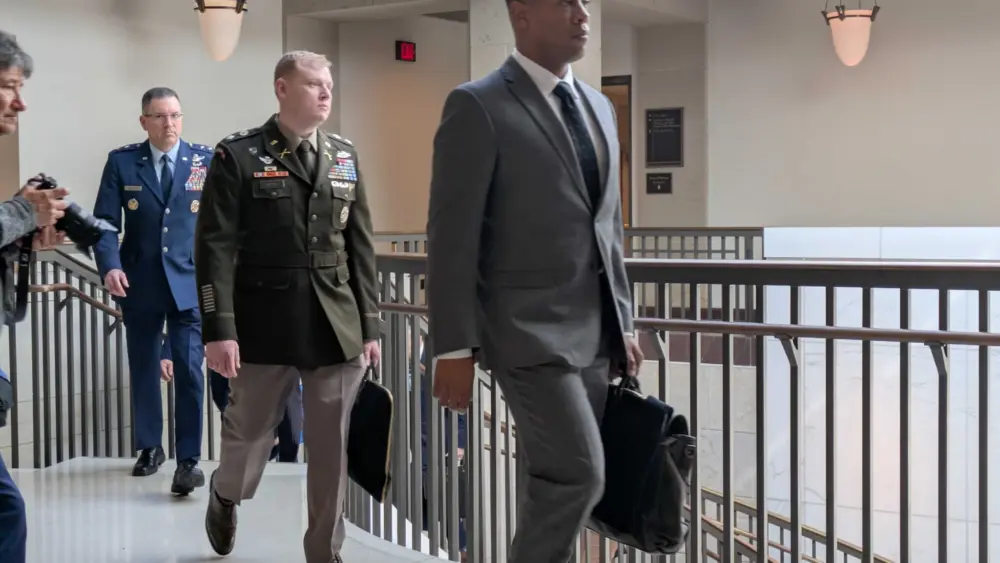 Pentagon officials ascend stairs on March 10, 2026, as they leave a classified briefing for members of the U.S. Senate on Capitol Hill. (Ashley Murray/States Newsroom)
