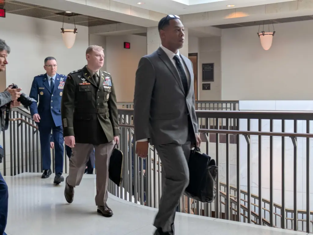Pentagon officials ascend stairs on March 10, 2026, as they leave a classified briefing for members of the U.S. Senate on Capitol Hill. (Ashley Murray/States Newsroom)