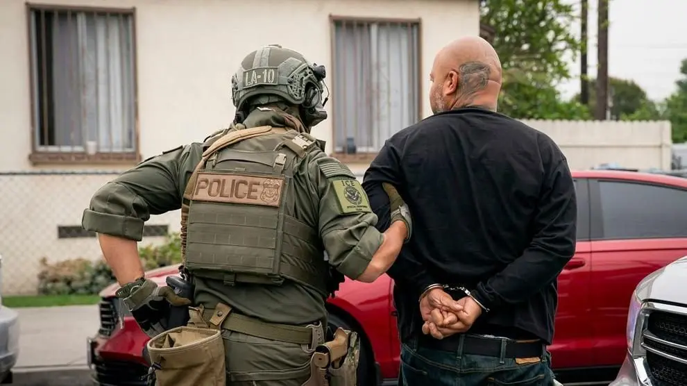 An ICE officer detains a handcuffed man in Los Angeles on June 12, 2025. Photo: Tia Dufour / U.S. Department of Homeland Security / Public Domain