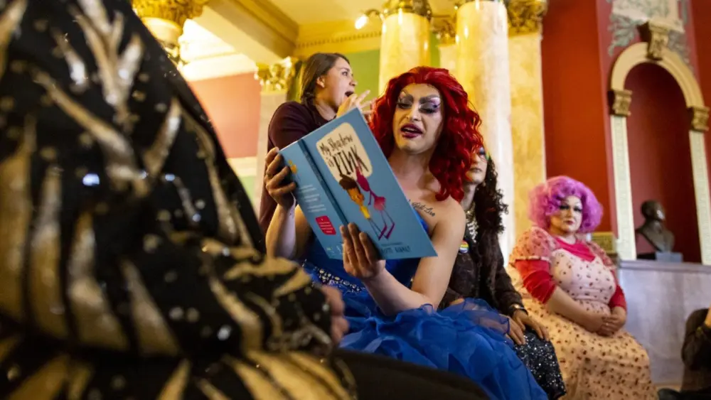 Stefan Aldava reads from “My Shadow is Pink” while performing as Sofia Shadow during a drag story hour in the rotunda of the Montana State Capitol in Helena on Thursday, April 13, 2023.