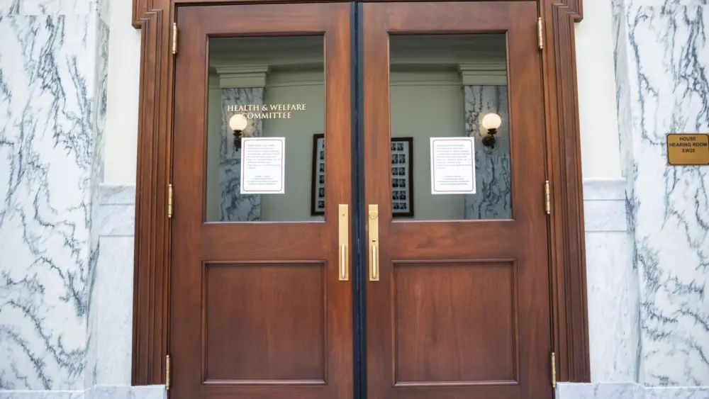 The door to the meeting room for the House’s Health and Welfare Committee as seen on March 10, 2025, at the Idaho Capitol Building in Boise. (Pat Sutphin for the Idaho Capital Sun)