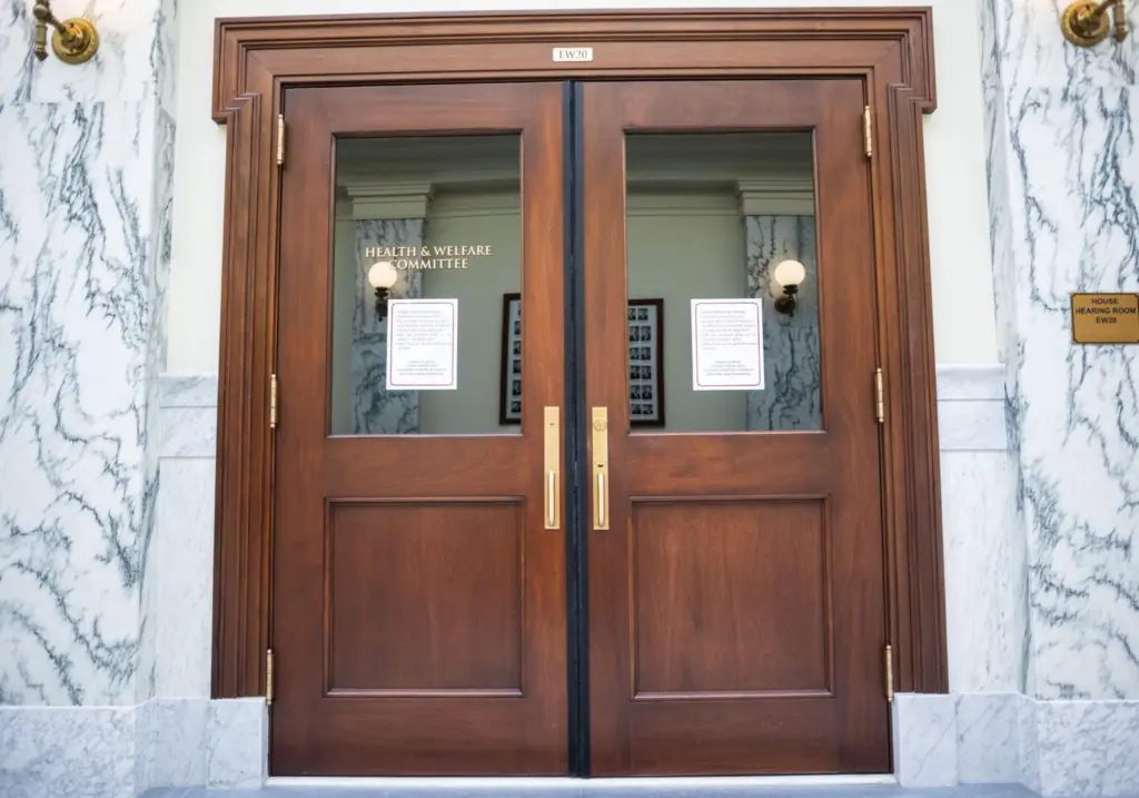 The door to the meeting room for the House’s Health and Welfare Committee as seen on March 10, 2025, at the Idaho Capitol Building in Boise. (Pat Sutphin for the Idaho Capital Sun)