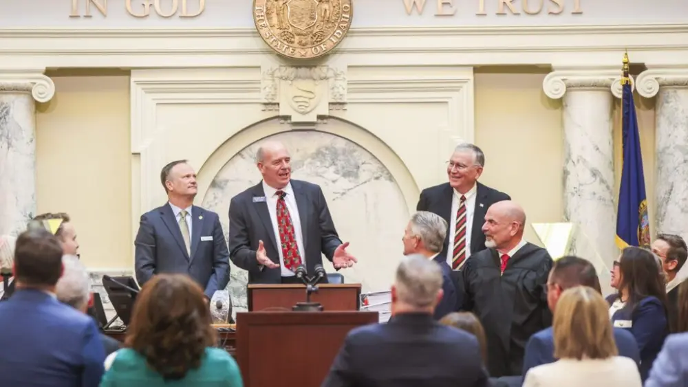 Idaho House Speaker Mike Moyle (behind lectern) speaks to Gov. Brad Little after the governor finished his State of the State Address on Jan. 12, 2026, at the State Capitol Building in Boise. (Photo by Pat Sutphin for the Idaho Capital Sun)