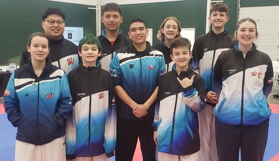 From left to right back row: Coach/Sensai Jon Morrow, Anton Arthur, CC Subis, and Milo Jones From left to right front row: Jayden Henderson, Zeus Fenwick, Luke Heavrin, Maverick Campbell, and Makaela Everheart - IEAAU Karate