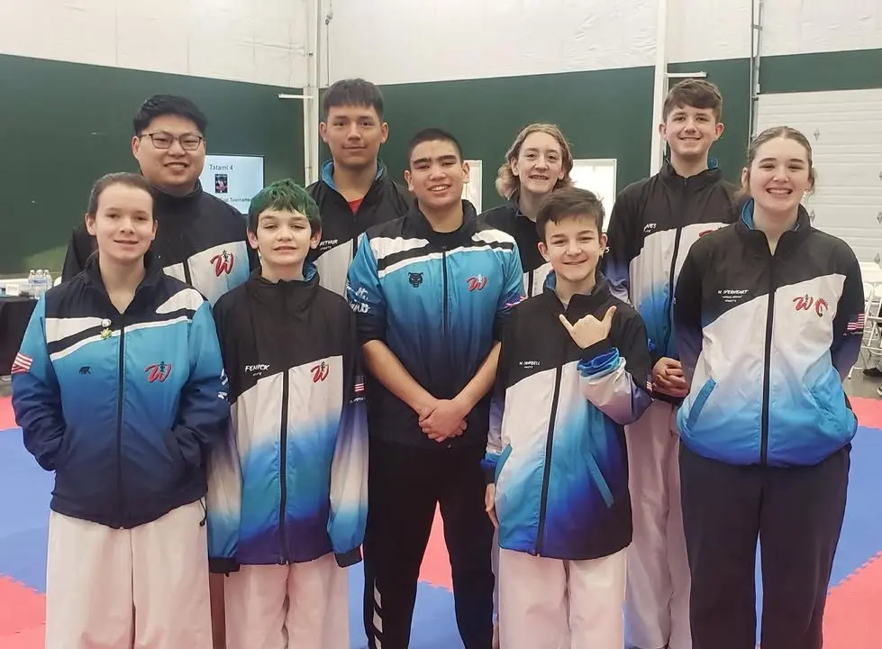 From left to right back row: Coach/Sensai Jon Morrow, Anton Arthur, CC Subis, and Milo Jones From left to right front row: Jayden Henderson, Zeus Fenwick, Luke Heavrin, Maverick Campbell, and Makaela Everheart - IEAAU Karate