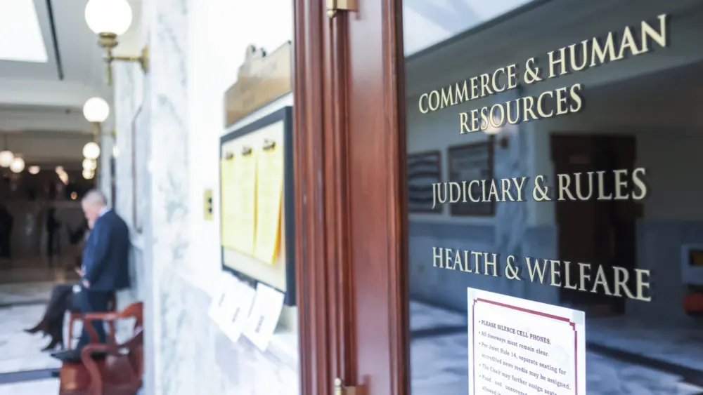 The entrance to the hearing room for the Idaho Senate’s Commerce and Human Resources, Judiciary and Rules, and Health and Welfare committees as seen on March 16, 2026, at the Idaho State Capitol Building in Boise. (Photo by Pat Sutphin for the Idaho Capital Sun)