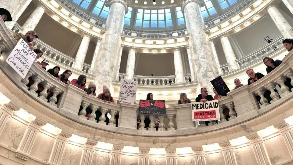 Hundreds of Idahoans gathered in the rotunda of the Idaho Capitol on Jan. 12, 2026, to protest budget cuts to the state’s Medicaid program. The protest, organized by Idaho Voices for Children, took place before the governor’s State of the State Address. (Photo by Christina Lords/Idaho Capital Sun)