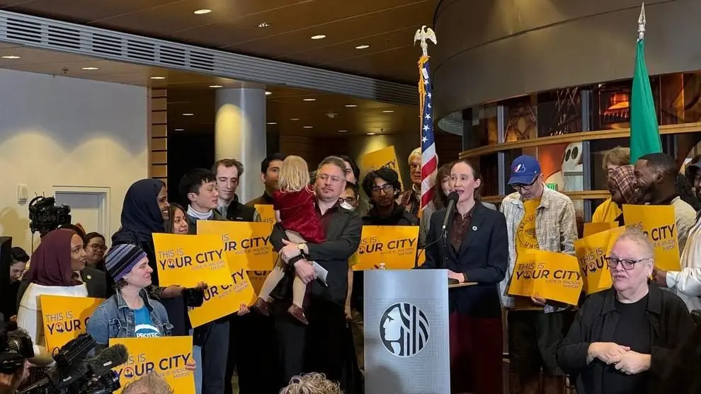 Seattle Mayor Katie Wilson speaks during her first address as mayor, surrounded by supporters holding signs. Photo: Spencer Pauley / The Center Square