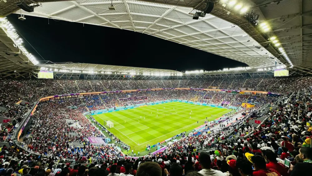 Fans fill a stadium during a match at the 2022 FIFA World Cup in Qatar. (Photo: Unsplash / Vishal Butolia)