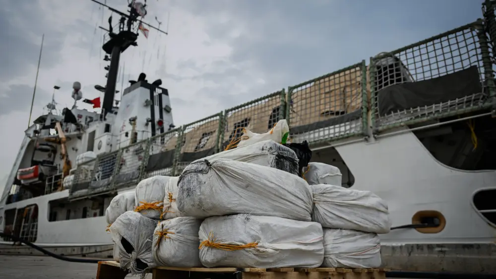 The crew of the Coast Guard cutter Vigorous offloads about 840 pounds of cocaine at Base Miami Beach, Fla., on June 5, 2025. Photo: Petty Officer 3rd Class Jessica Walker / U.S. Coast Guard via DVIDS / Public Domain