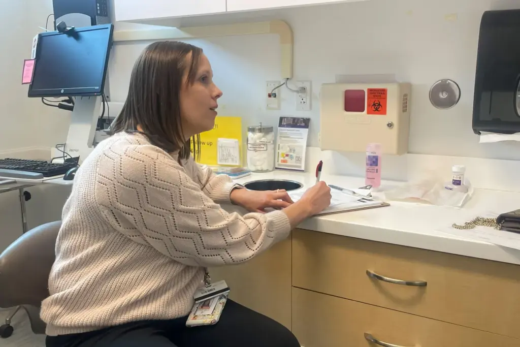 Jessica Norton is an OB-GYN who treats many patients with Medicaid coverage at an Affinia Healthcare clinic in St. Louis. She worries many of her patients are at risk of losing their health coverage under new Medicaid work requirements because they’re caring for their parents or other family members full-time. (Samantha Liss/KFF Health News)