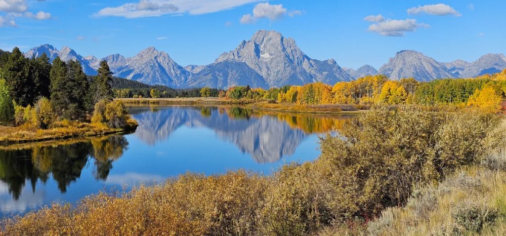 Wyoming’s Mount Moran’s reflection ripples across the waters of Oxbow Bend on a crisp fall day in 2025. (Photo by Rebecca Huntington/WyoFile)