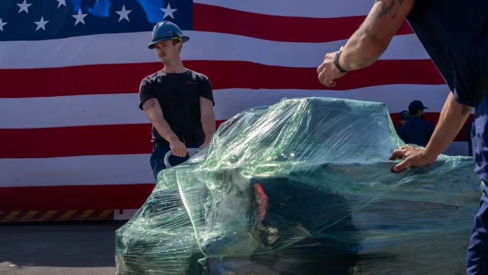 Boatswain’s Mate 2nd Class Carson Williams moves a pallet of seized cocaine aboard the Coast Guard cutter Kimball in San Diego on April 24, 2025. Photo: Petty Officer 3rd Class Austin Wiley / U.S. Coast Guard via DVIDS / Public Domain