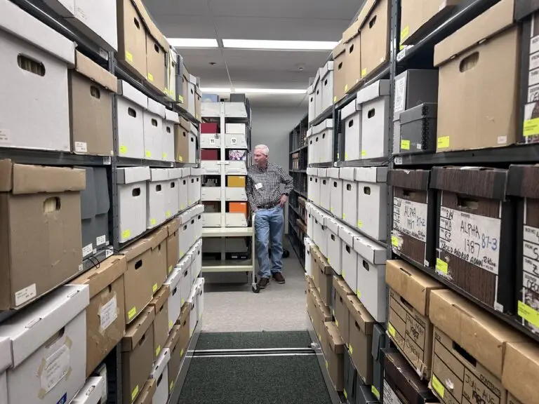 Longtime Idaho journalist and former president of Idaho Businesses for Education Rod Gramer stands among the reference materials in the Cecil D. Andrus Papers in the Special Collection and Archives at the Albertsons Library at Boise State University. The collection includes 40 years’ worth of correspondence, memoranda, press releases, calendars, reports and materials documenting Andrus’ service as U.S. secretary of the Interior and also personal items pertaining to his five campaigns for governor and the Idaho Legislature. (Photo by Christina Lords/Idaho Capital Sun)