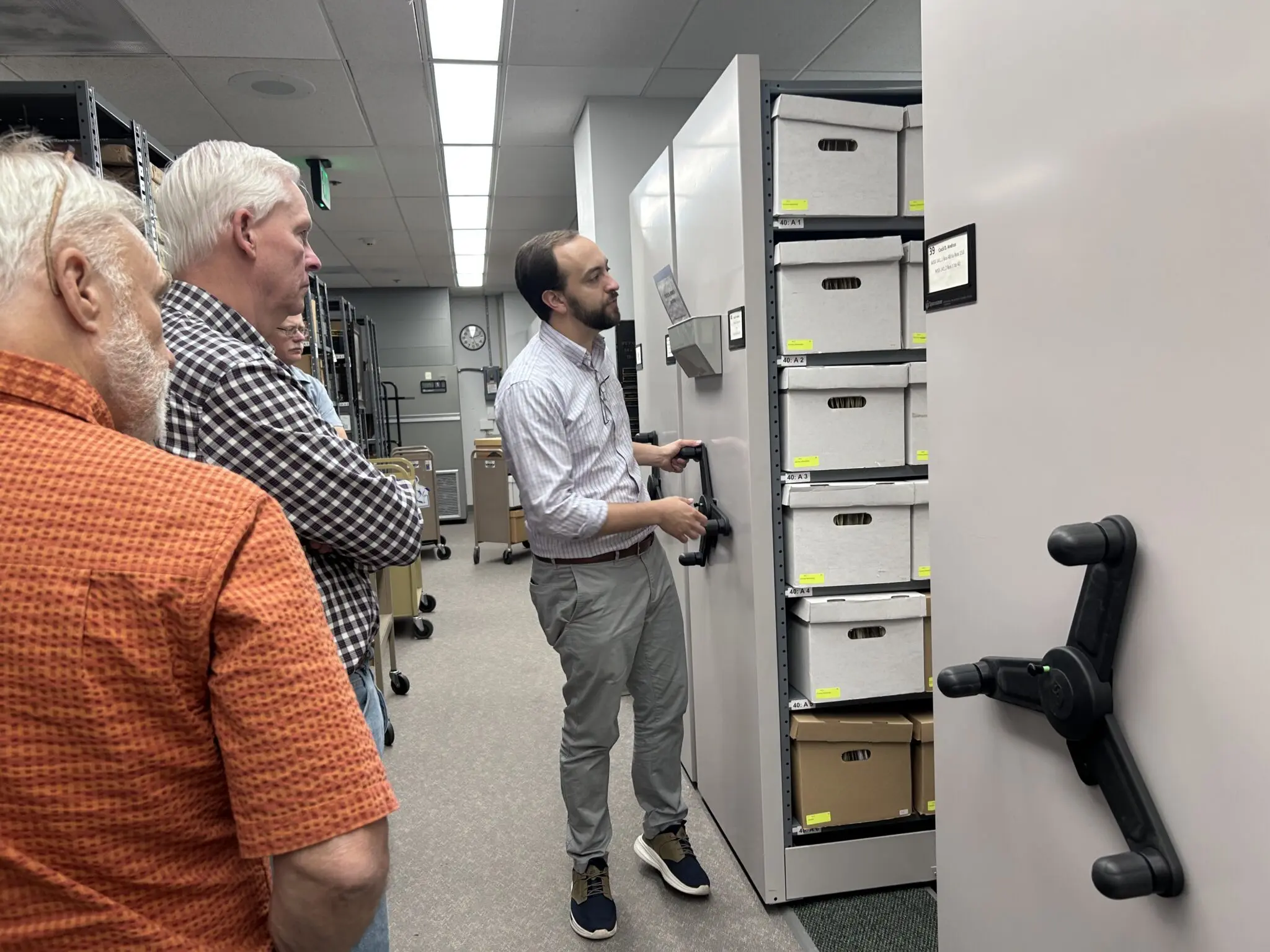 Boise State University archivist and librarian Alessandro Meregaglia (right) moves shelves at the Alberstons Library lined with archival material from the administrations of Cecil D Andrus, who served as a state legislator, Idaho governor and the U.S. secretary of the Interior. (Photo by Christina Lords/Idaho Capital Sun)