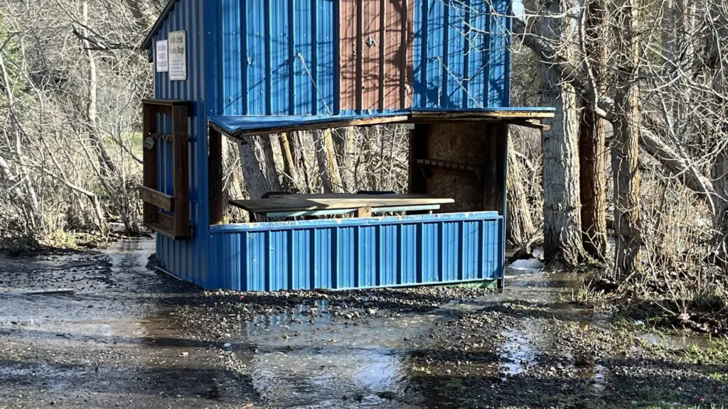 A shooting shed on the Asotin Creek Shooting Range surrounded by water.