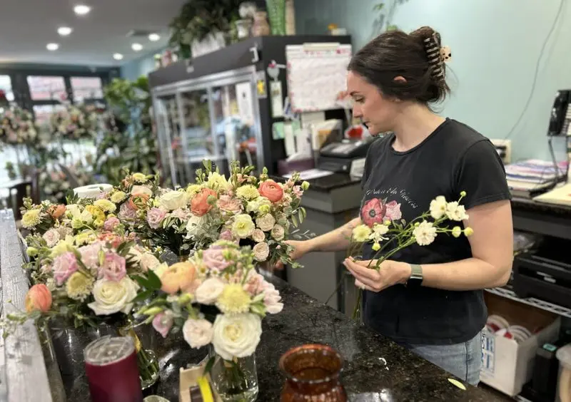 A floral designer in Newport, R.I., creates bouquets on April 30. A growing number of states, including Rhode Island, are launching retirement plans for workers who don’t have access to plans through their employers. (Photo by Janine L. Weisman/Rhode Island Current)