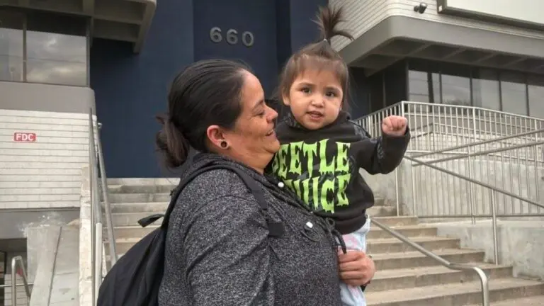 Carmen Cancino and her daughter Ximena Lopez at a December protest against arrests of immigrants at green card appointments in Salt Lake City. The Trump administration is threatening to force legal immigrants applying for green cards to return home first and wait for processing. (Photo by Annie Knox, Utah News Dispatch)