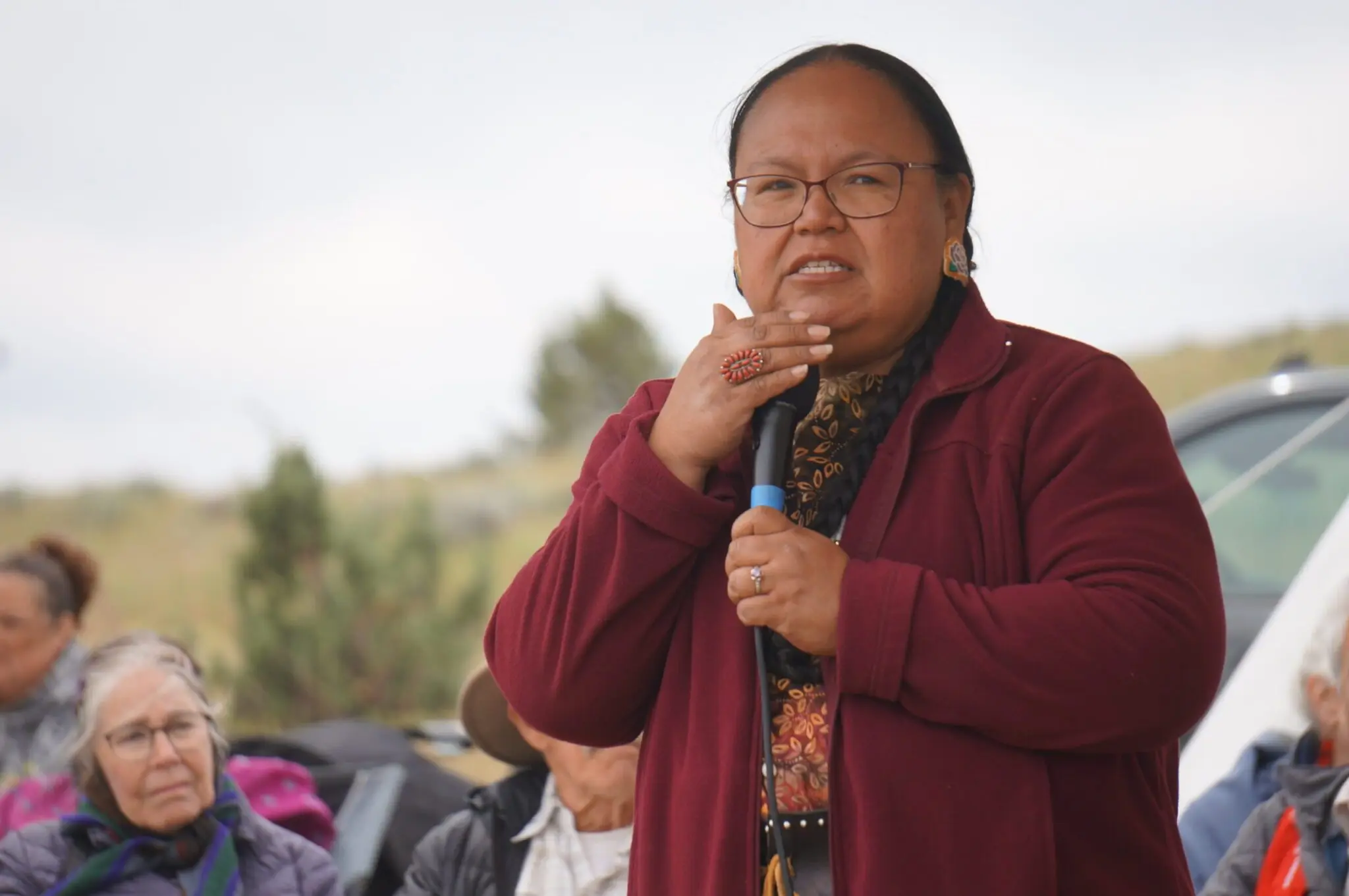 Elaine Harvey, a member of the Yakama Nation and a watershed manager at the Columbia River Inter-Tribal Fish Commission speaks at an event near Pushpum, a site sacred to Columbia River tribes near Goldendale, Wash. on Friday, May 8, 2026. (Photo by Alex Baumhardt/Oregon Capital Chronicle)