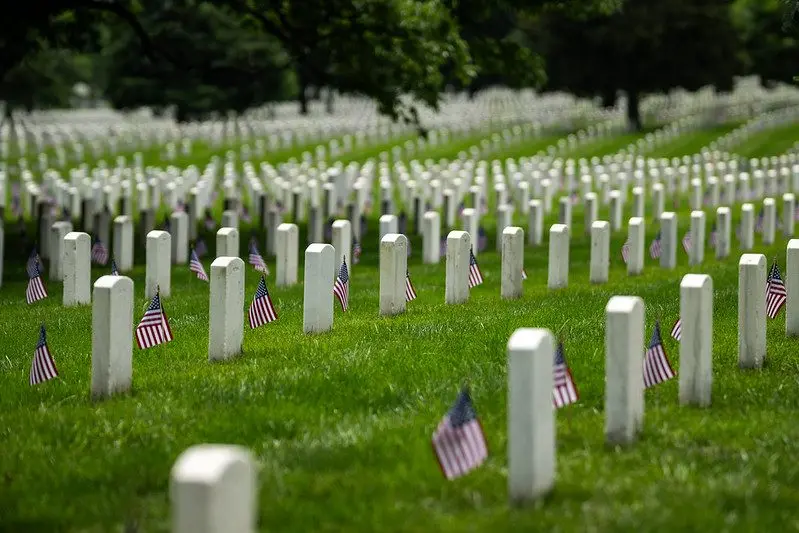 U.S. flags are placed at headstones during Memorial Day at Arlington National Cemetery in Arlington, Va., on May 26, 2025. Photo: Daniel Torok / Official White House Photo via Flickr / United States Government Work
