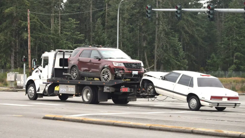 Vehicles are transported by a tow truck in this file photo. Idaho officials say updates to the state’s Abandoned Vehicle Portal will help consumers locate and reclaim towed vehicles faster. Photo by fr0ggy5 on Unsplash