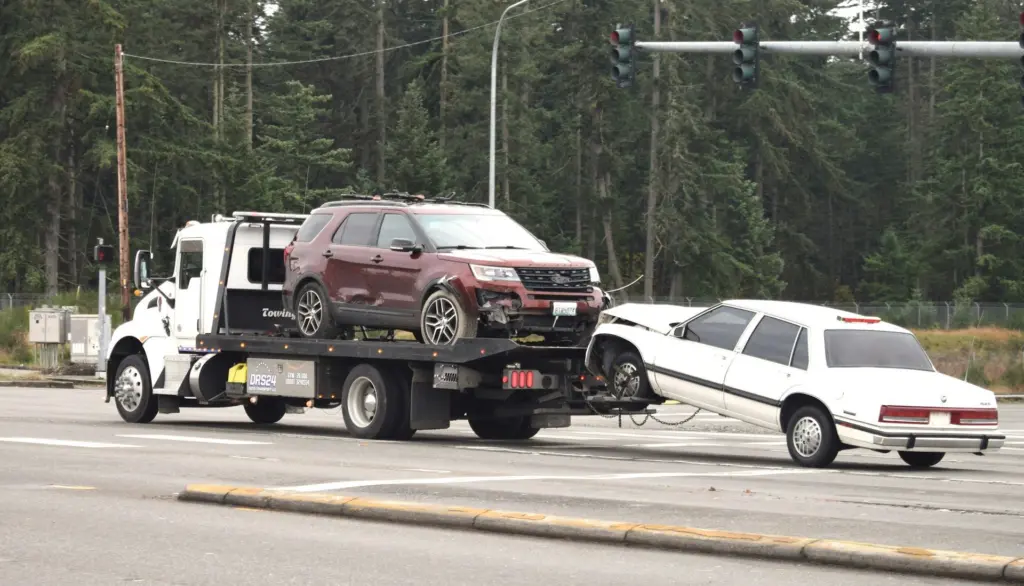 Vehicles are transported by a tow truck in this file photo. Idaho officials say updates to the state’s Abandoned Vehicle Portal will help consumers locate and reclaim towed vehicles faster. Photo by fr0ggy5 on Unsplash