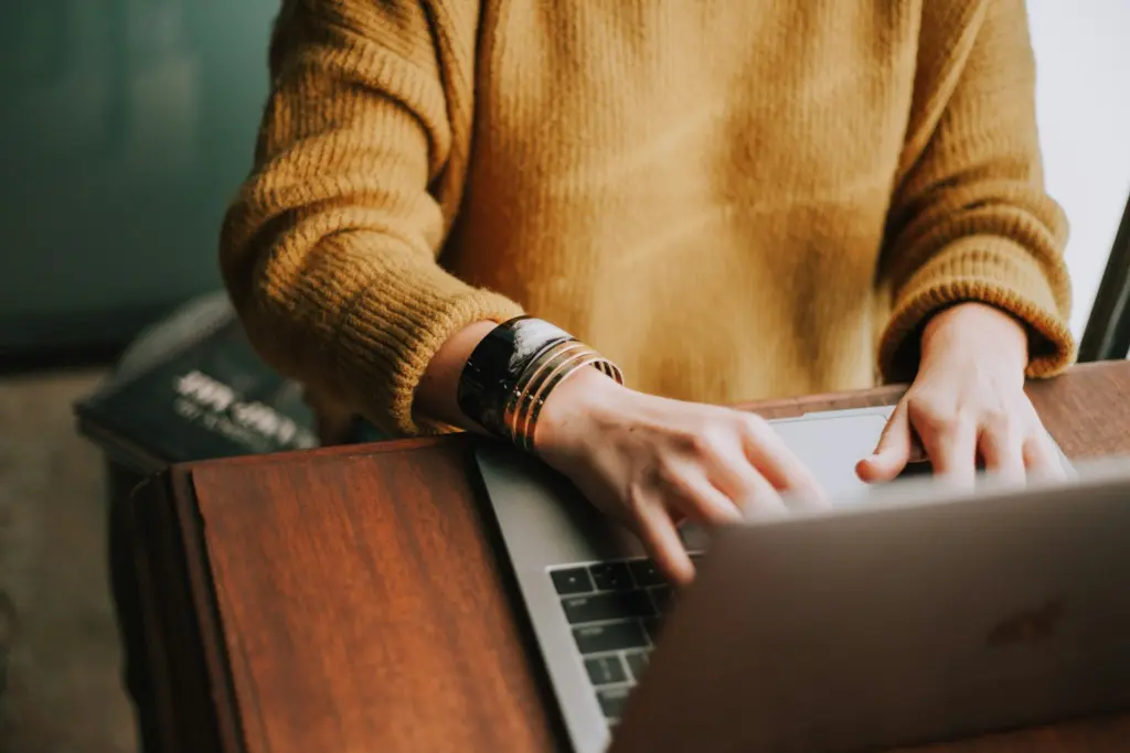 A worker uses a laptop in an office setting. Idaho Attorney General Raúl Labrador has joined a multi-state coalition supporting higher wage requirements under the H-1B visa program. Photo credit: Photo by Christin Hume on Unsplash.