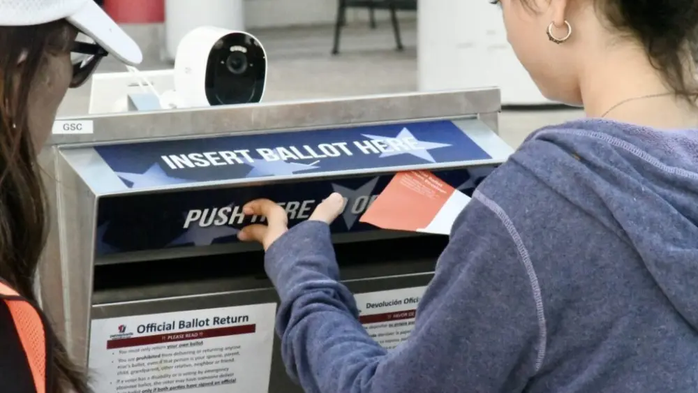 A voter deposits a mail-in ballot at the drop box outside the Chester County Government Center on Tuesday, Nov. 5, 2024. (Photo by Peter Hall/Pennsylvania Capital-Star)