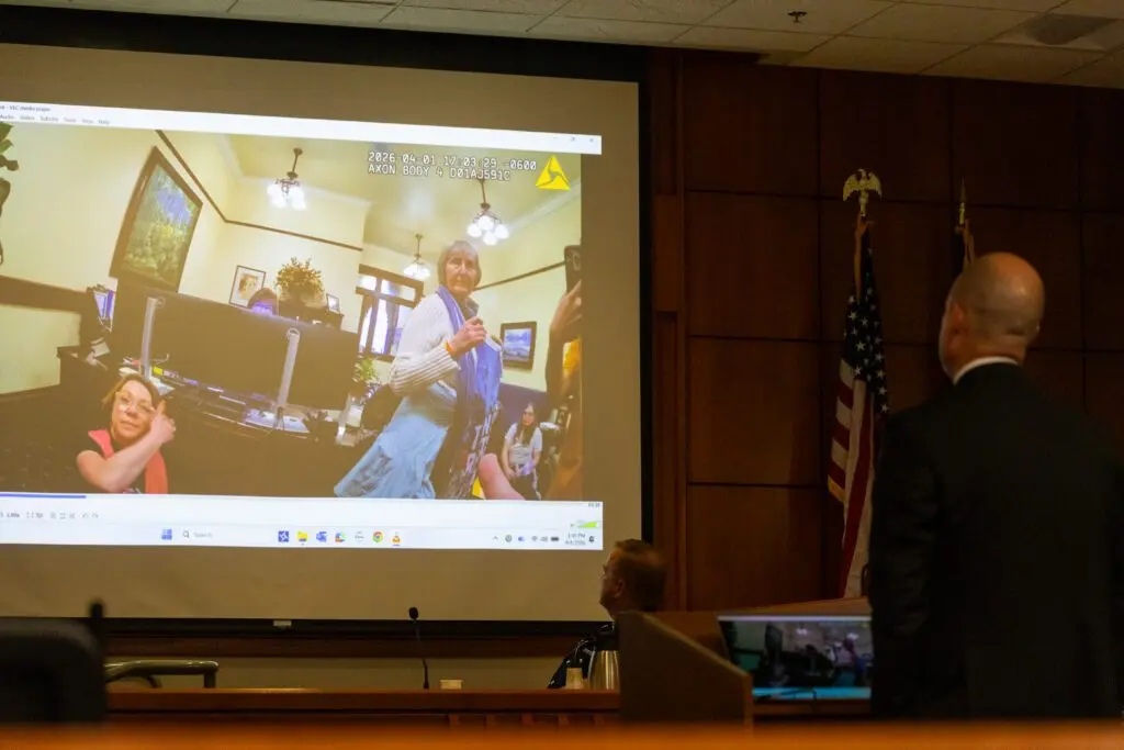 An Ada County prosecuting attorney and an Idaho State Police trooper watch body cam footage leading up to the arrest of the Rev. Sara LaWall on trespassing charges at her trial in Boise on Sept. 1, 2026. (Photo by Kyle Pfannenstiel/Idaho Capital Sun)