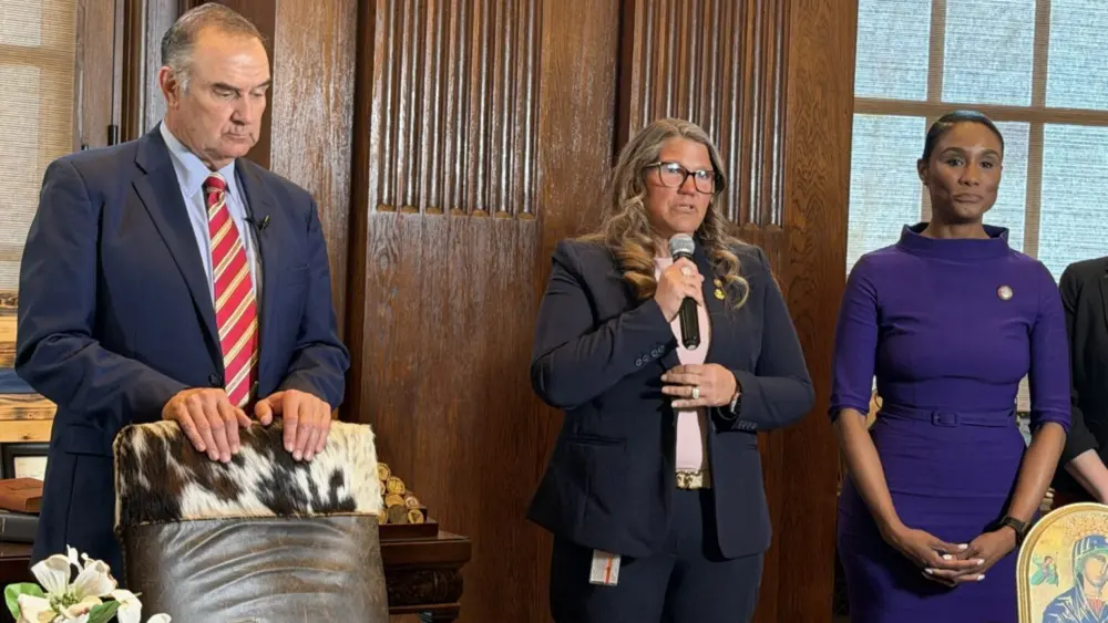 Missouri Republican state Rep. Cecelie Williams, flanked by Republican Gov. Mike Kehoe and Democratic state Rep. Raychel Proudie, speaks in April about legislation that clarifies the right to divorce while pregnant. In recent decades, most of the states that have tweaked their divorce laws have made it easier, not harder, to get one. But that may be changing. (Photo by Steph Quinn/Missouri Independent)