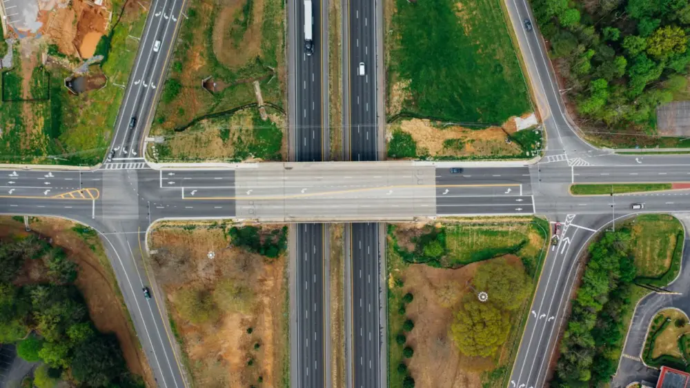 Photo by K : https://www.pexels.com/photo/highway-junction-with-marking-lines-near-green-trees-in-suburb-4030647/