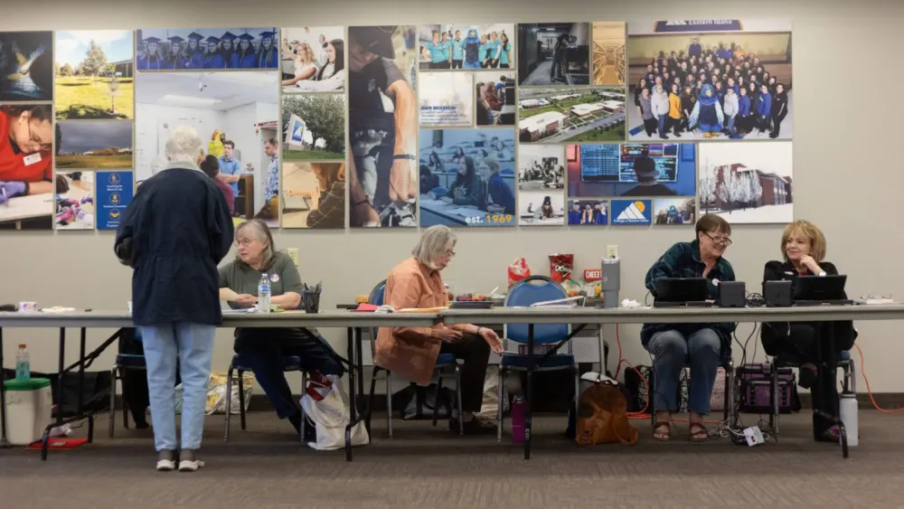 Bonneville County poll workers help voters get their ballots for the primary election on May 21, 2024 at the College of Eastern Idaho in Idaho Falls. (Pat Sutphin for the Idaho Capital Sun)